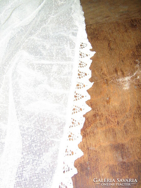 Beautiful vintage crocheted rococo style curtain decorated with dark pink ribbon with lace edge