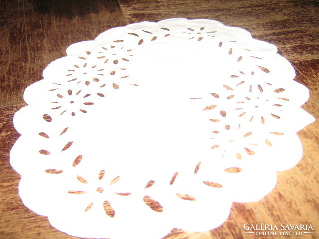A charming hand-embroidered display tablecloth with a slinged edge