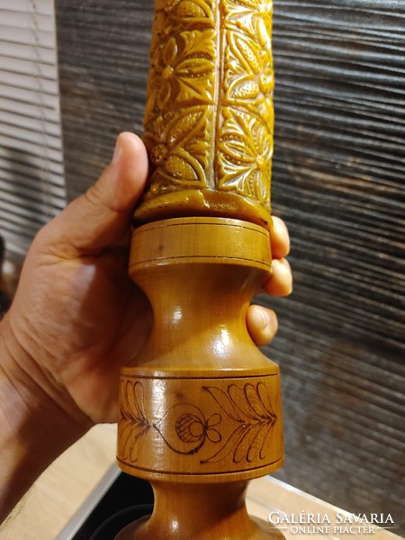Antique candle with carved wooden holder