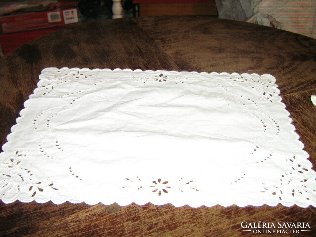 A charming hand-embroidered display tablecloth with a slinged edge
