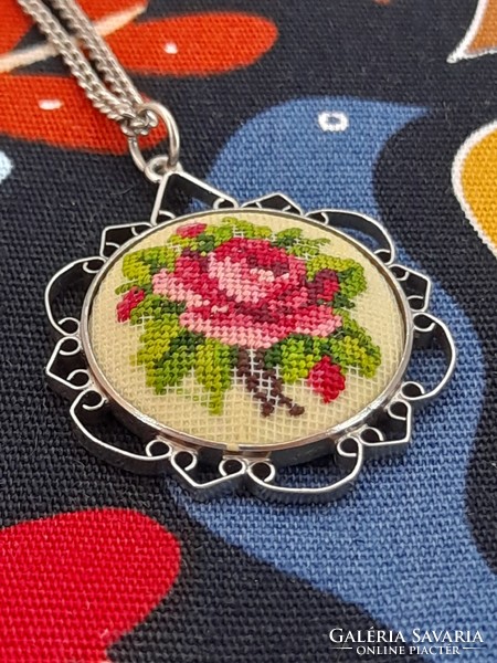 Pink needle tapestry pendant on a chain, 3.5 cm