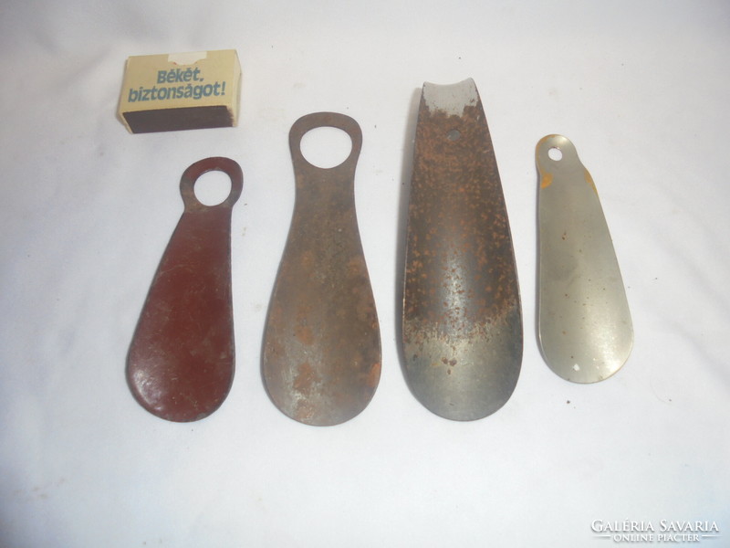 Four old metal shoe spoons together - one enameled