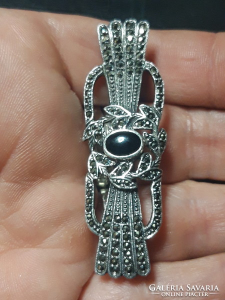 Old silver brooch with onyx stone