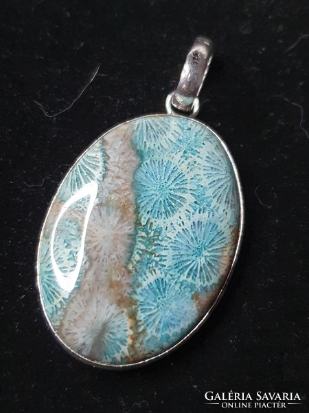 Beautiful silver pendant with a polished coral stone