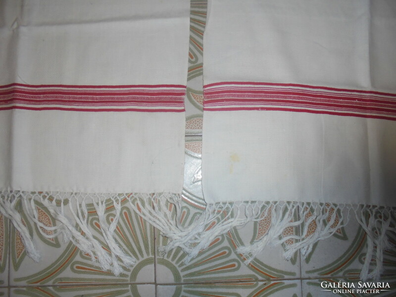 Two pieces of retro home-woven, fringed towels together