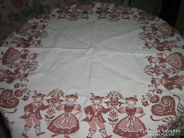Beautiful vintage bavarian motif on an off-white background Tyrolean girl-boy with floral kind woven tablecloth