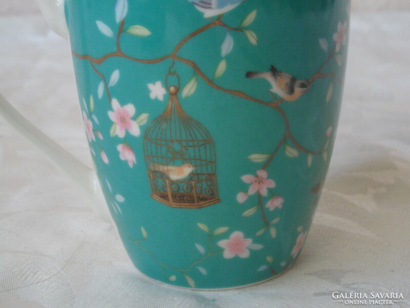 Porcelain mug with bird cage and flowers