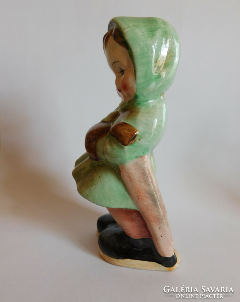 Vintage ceramic girl figure in winter clothes