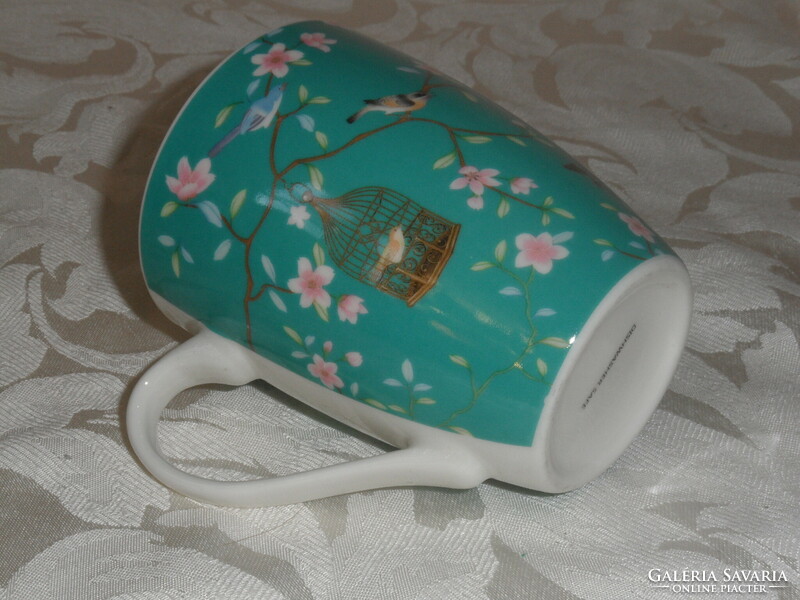 Porcelain mug with bird cage and flowers