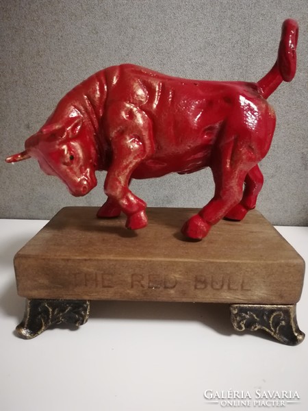 Heavy, solid cast-iron bull statue heated by energy, red bull