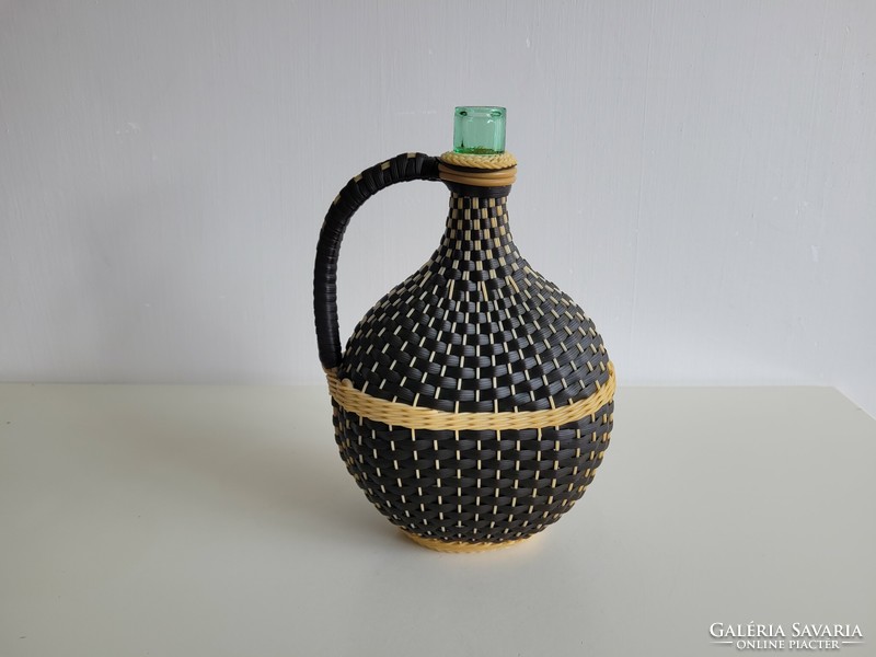 Old woven glass wine brandy bottle on a green ham glass demison