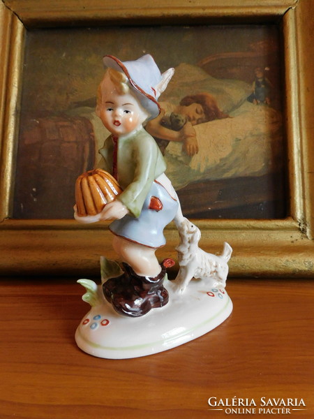 Old German porcelain figure - a little boy protecting his dog from his dog
