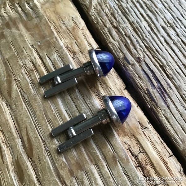 Modernist silver-colored cuff with a cone-shaped blue glass stone