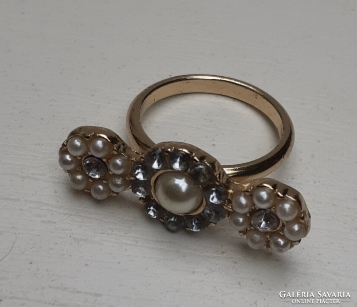 Retro gold-colored women's ring decorated with white and pale blue stones
