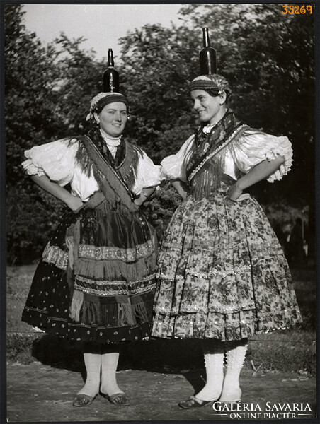 Larger size, photo art work by István Szendrő. Women, in Báta folk costume, with glass.