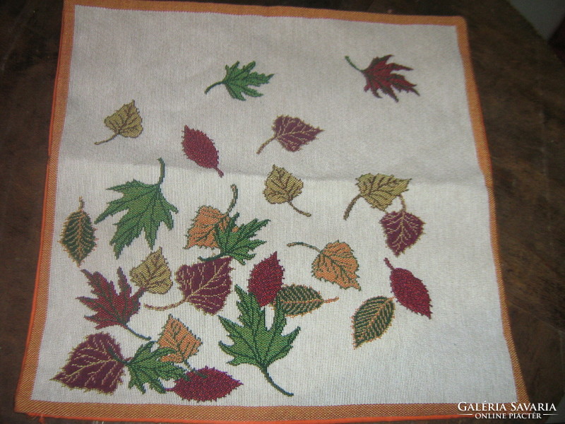 Beautiful decorative cushion with woven autumn leaves