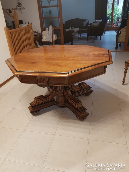 Antique extendable dining table with 6 carved upholstered chairs