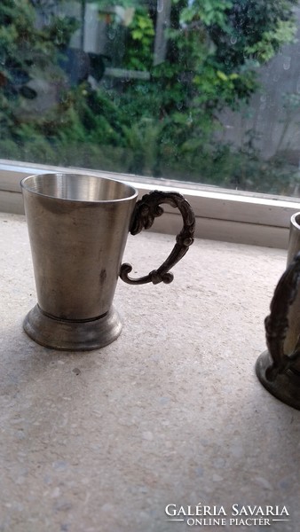 2 glasses with tin ears.