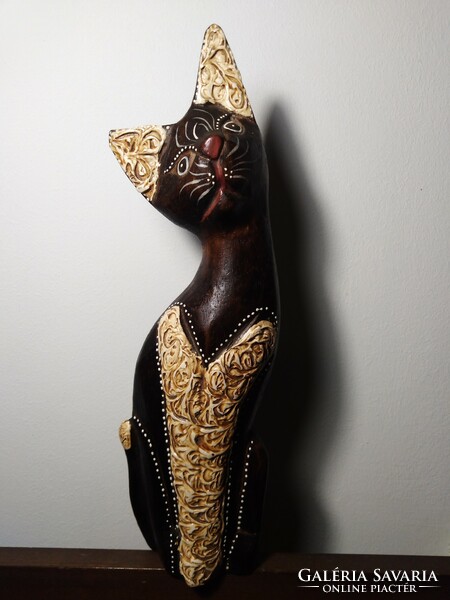 A carved wooden cat statue