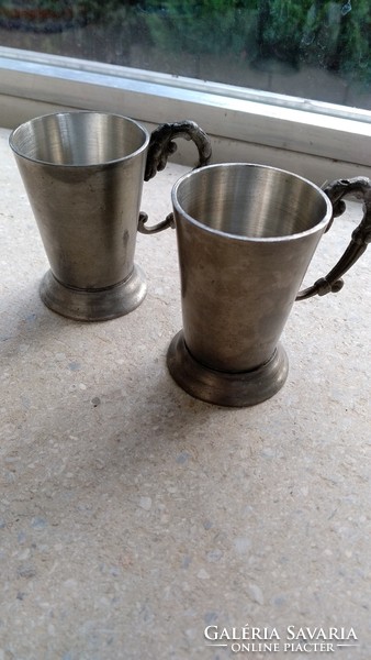 2 glasses with tin ears.