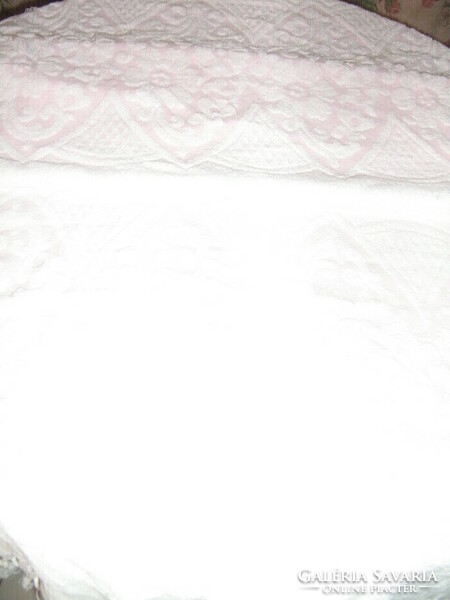 White and pink fringed towel with a printed pattern in its beautiful fabric