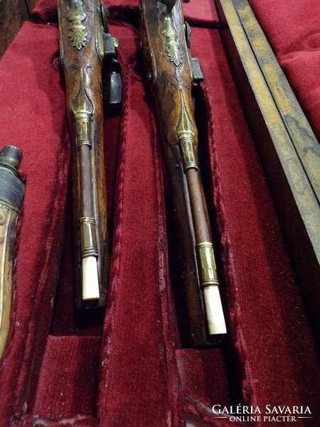 Pair of baroque French flintlock pistols, in box