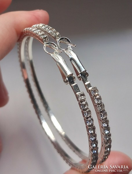 Silver-plated rhinestone hoop earrings.