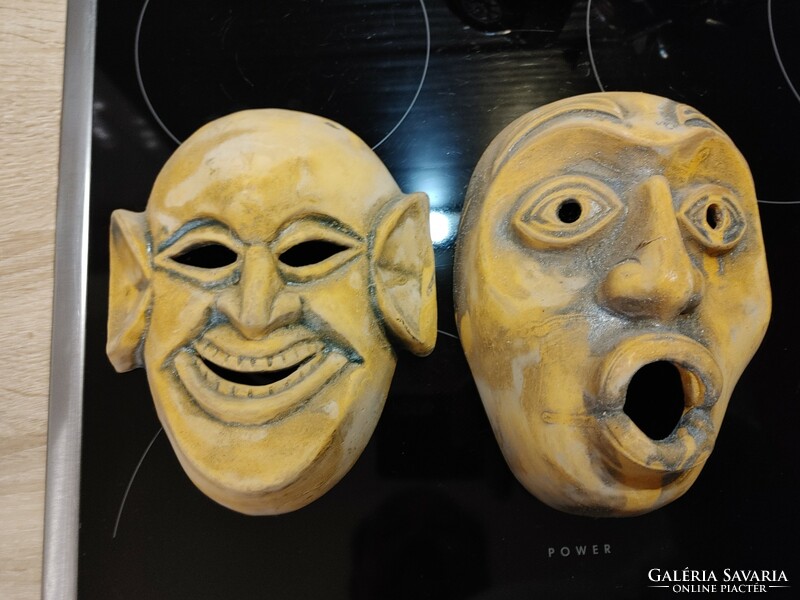 A pair of ceramic theater masks with a laughing-amazing face