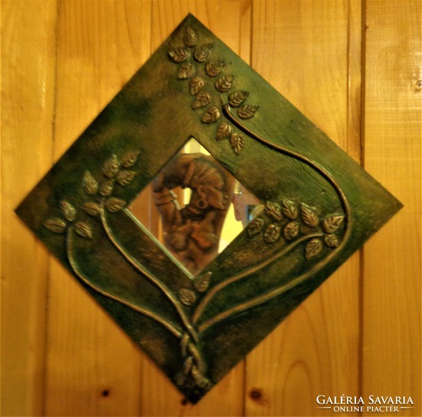 Decorative small mirror, decorated with copper tendrils, on a painted wooden sheet / 