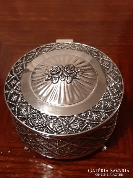 A wonderful silver-plated jewelry box with a rich pattern and a plush lining inside