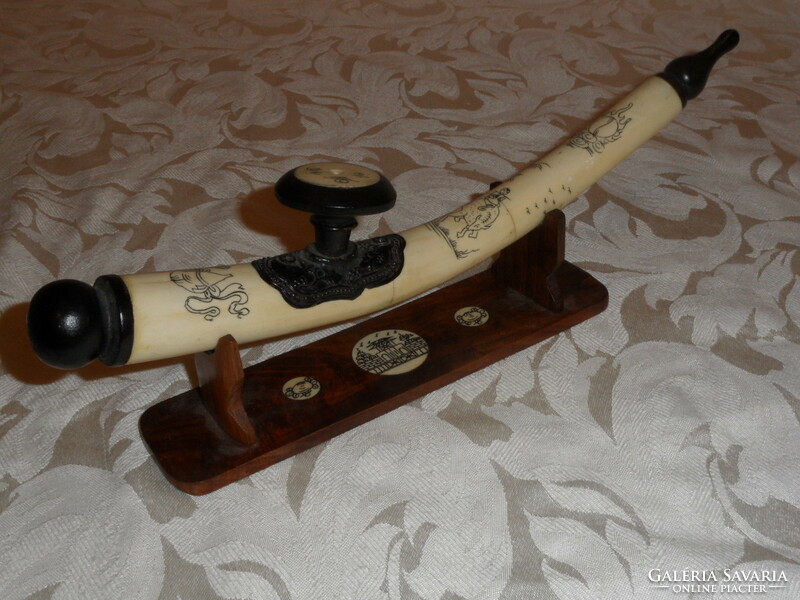 Far Eastern hand-painted, bone opium pipe on a wooden stand