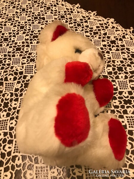 A new, snow-white teddy bear. With red ears and red paws. Made in Korea. Great for a Christmas present.