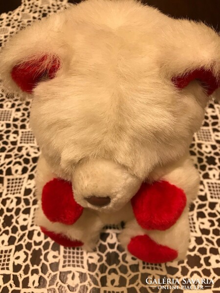A new, snow-white teddy bear. With red ears and red paws. Made in Korea. Great for a Christmas present.