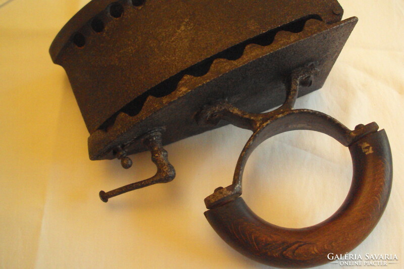 Antique fiery iron --- a kitchen tool made of cast iron heated with embers, used for ironing.