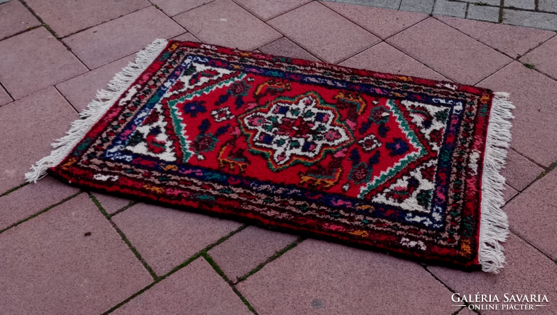 An old hand-knotted oriental wool rug with beautiful colors