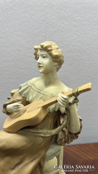 A very rare 100-year-old royal dux figure of a woman playing guitar