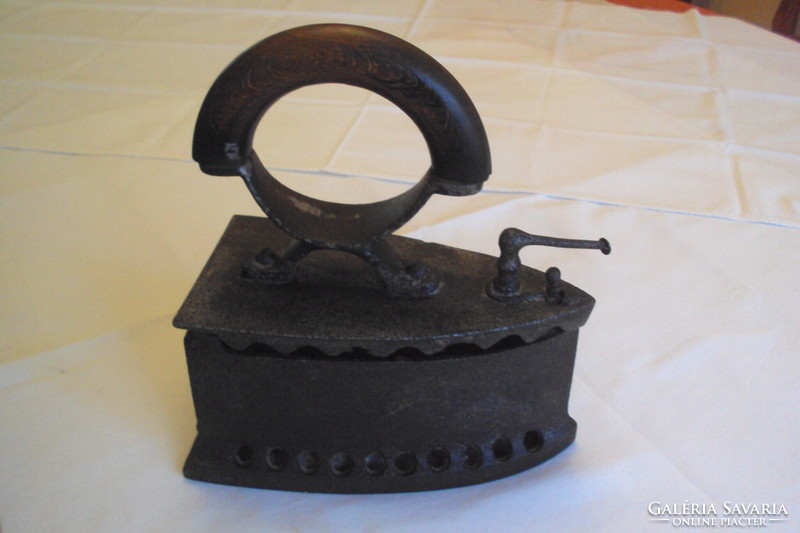 Antique fiery iron --- a kitchen tool made of cast iron heated with embers, used for ironing.