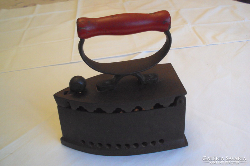 Antique fiery iron --- a kitchen tool made of cast iron heated with embers, used for ironing.