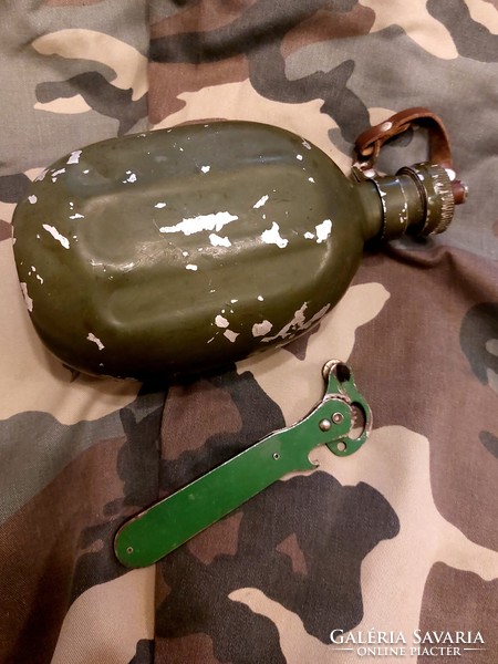 Military water bottle and can opener for sale together.