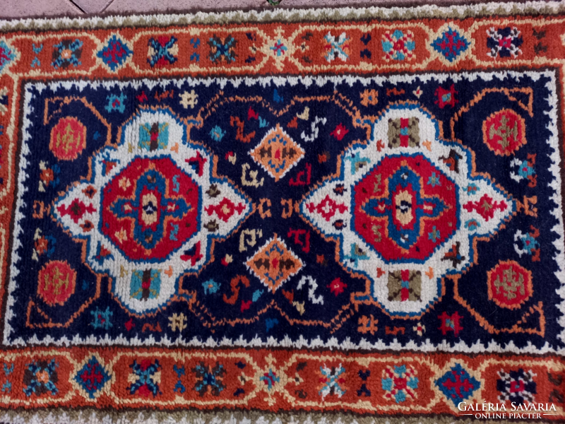 An old hand-knotted oriental wool rug with beautiful colors