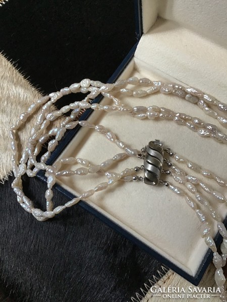 4-row string of river pearls with a modern silver clasp