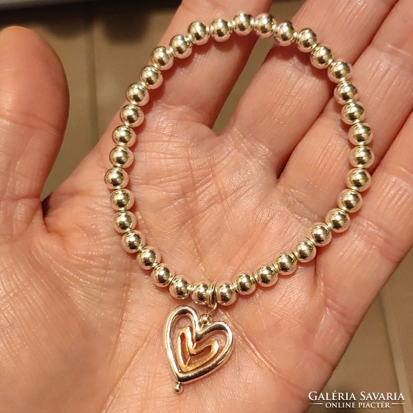 New silver-colored rubber bracelet with a gold-plated heart