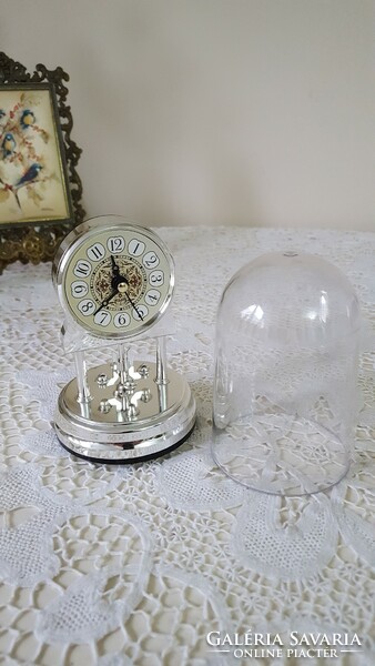 Small silver table clock with pendulum