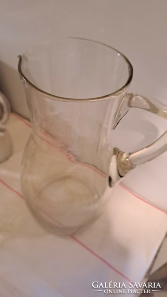 Old decorative glass jug, pouring
