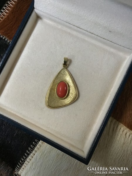 Old vintage gilded pendant with precious coral stone