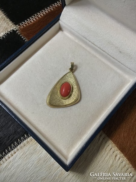 Old vintage gilded pendant with precious coral stone