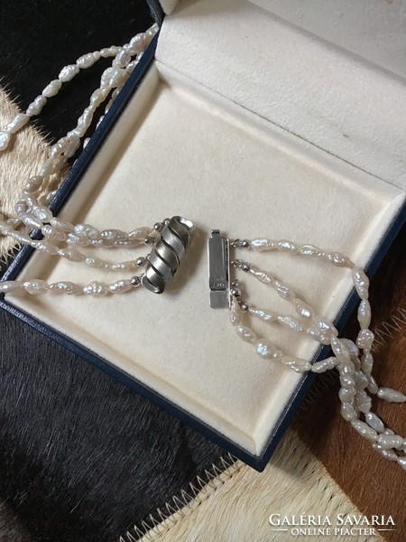 4-row string of river pearls with a modern silver clasp