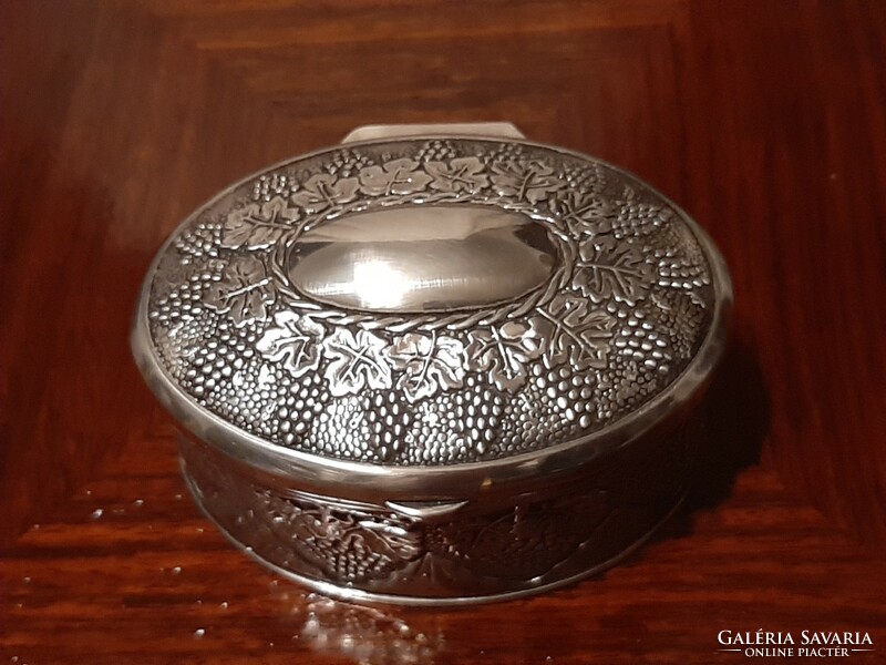 Beautiful richly decorated, oval silver-plated jewelry box with plush lining inside