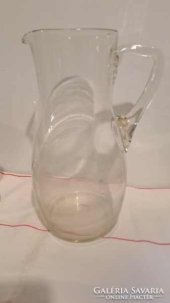 Old decorative glass jug, pouring