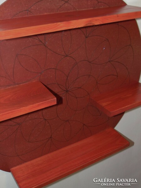 Cherry-colored shelf with a mandala pattern